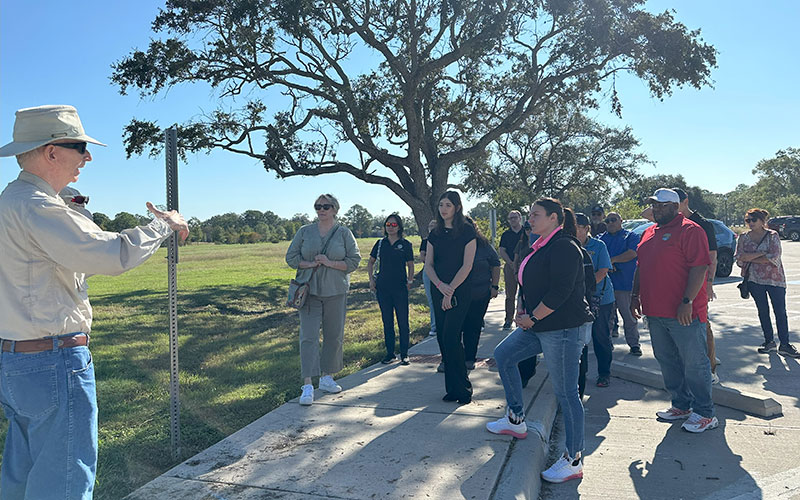 Group of people listening to a man speak