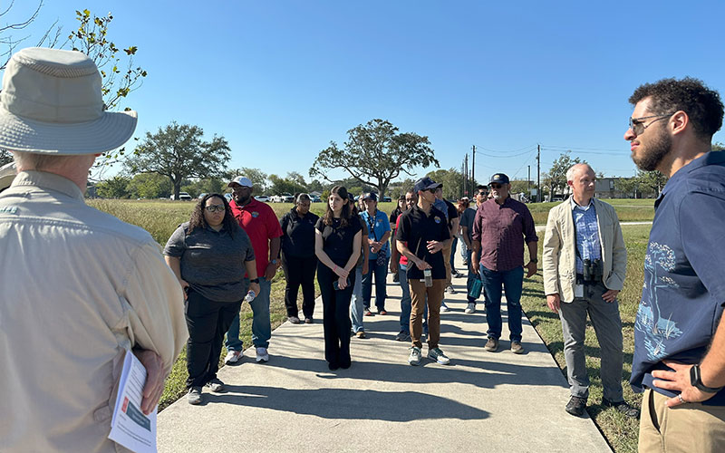 Man talking to a group of people outside